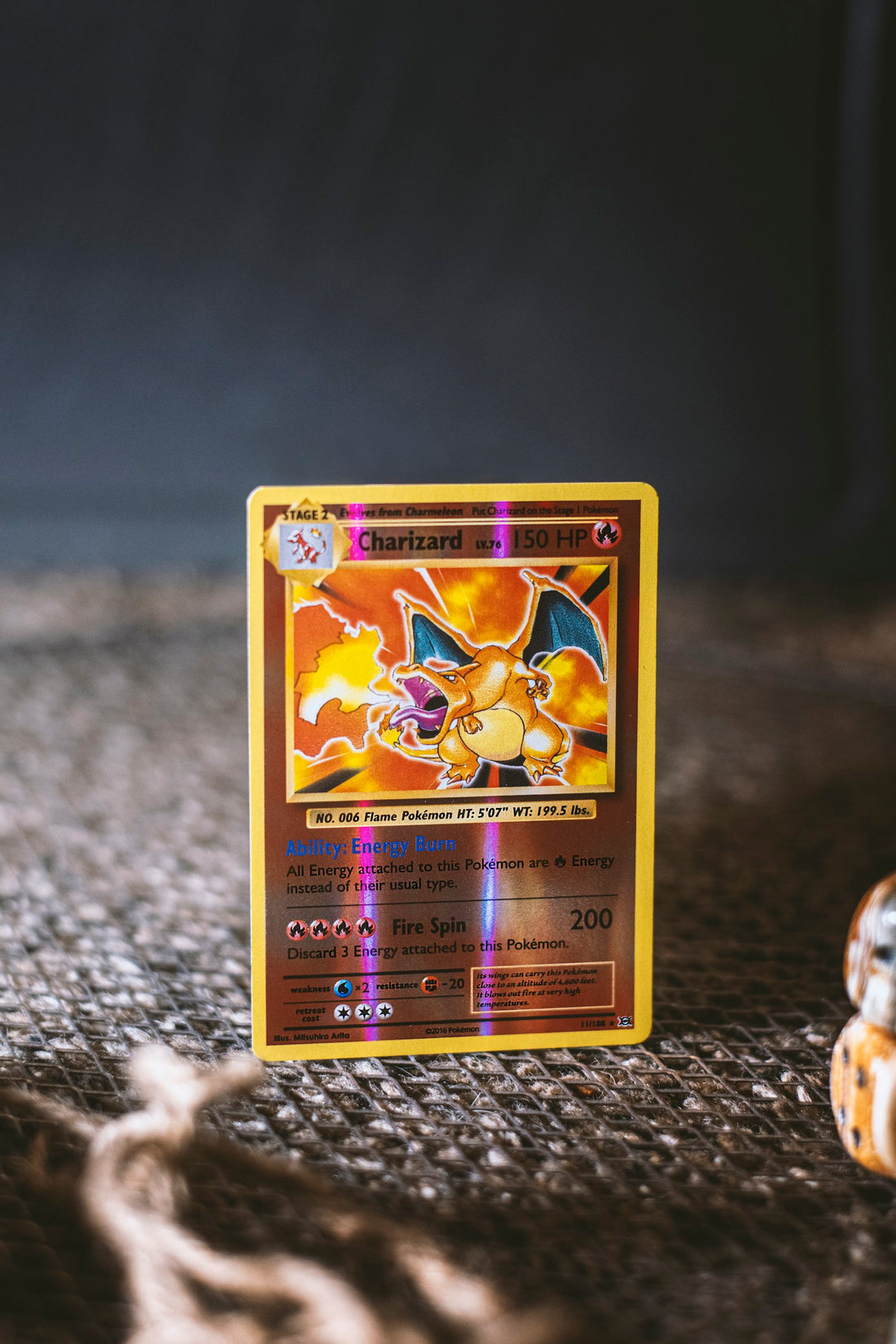 Photo: Steven Cordes on Unsplash — a holographic Charizard Pokémon card