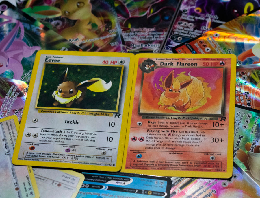 Photo: Halfcut Pokemon on Unsplash — a spread of Pokémon cards on a table