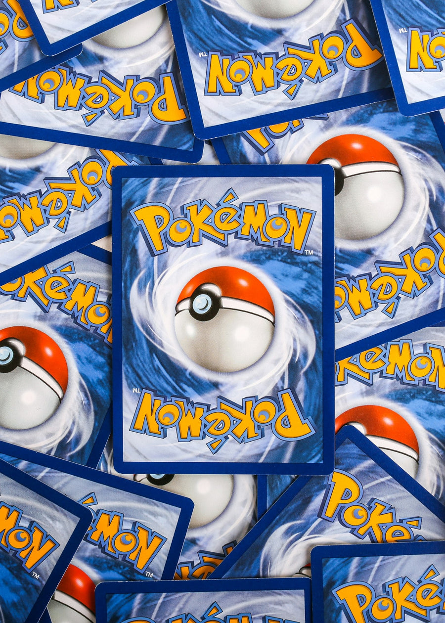 Photo: Giorgio Trovato on Unsplash — a large unsorted pile of old Pokémon trading cards, the kind found in a childhood collection